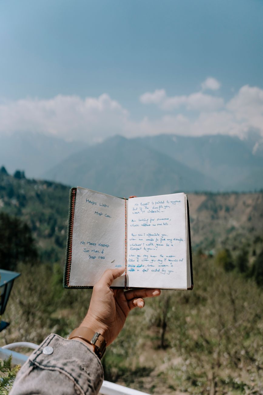 Travel journal editor taking field notes at sunrise